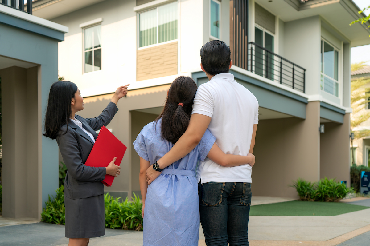 Asian woman Real estate broker agent showing a house project det