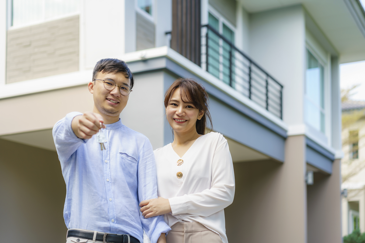 Portrait of Asian young couple standing and hugging together and