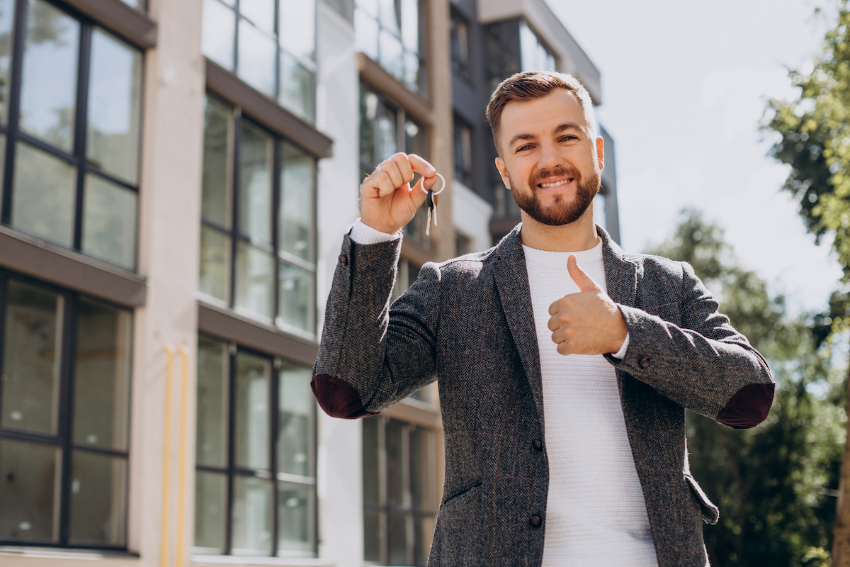 Young man with keys just bought new appartment